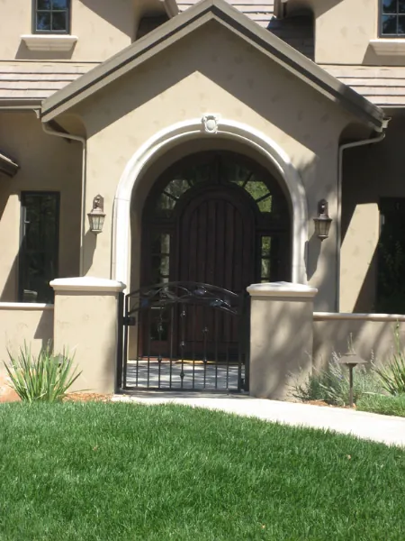 Arched wrought iron double door with scrollwork